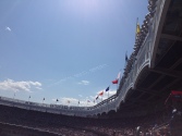 The frieze and teams flags lining the top of the stadium, modeled after that of the old stadium